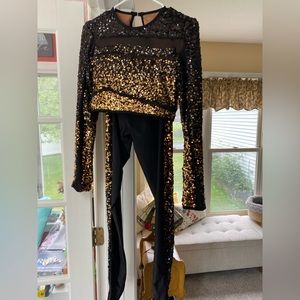 Medium Adult two-piece black and gold costume.
